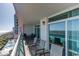 Relaxing balcony overlooking the ocean with outdoor furniture and sliding glass doors at 1903 S Ocean Blvd. S # 708, North Myrtle Beach, SC 29582