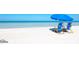 Two beach chairs under a blue umbrella on a pristine beach at 1903 S Ocean Blvd. S # 708, North Myrtle Beach, SC 29582