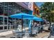 Outdoor cafe seating with blue umbrellas near shops at 1903 S Ocean Blvd. S # 708, North Myrtle Beach, SC 29582