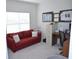 Bright home office features a red couch, work desk, and ample natural light at 2013 Great Blue Heron Dr., Little River, SC 29566