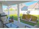 Covered patio with seating area, swing, and grill at 2013 Great Blue Heron Dr., Little River, SC 29566