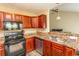 Modern kitchen with dark wood cabinets, black appliances, and granite countertops at 333 Carolina Springs Ct., Conway, SC 29527