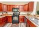 Modern kitchen with dark wood cabinets, black appliances, and granite countertops at 333 Carolina Springs Ct., Conway, SC 29527