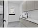 Bright laundry room features modern cabinetry, quartz countertops, and a stylish sink at 891 Waterton Ave., Myrtle Beach, SC 29579