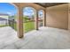 Covered balcony with arched details, tile flooring and backyard view at 891 Waterton Ave., Myrtle Beach, SC 29579
