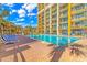 Refreshing outdoor pool with lounge chairs and nearby playground at 6900 N Ocean Blvd. # 1040, Myrtle Beach, SC 29572