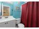 Bathroom with a toilet, vanity, and red shower curtain at 5905 S Kings Highway # 210B, Myrtle Beach, SC 29575