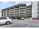 Building exterior showcasing ample parking and oceanfront location at 5905 S Kings Highway # 210B, Myrtle Beach, SC 29575