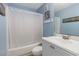 Bathroom with a tub shower, white vanity, and beach-themed decor at 5905 S Kings Highway # 210B, Myrtle Beach, SC 29575