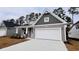 Two-story house with gray siding and white garage door at 1205 Nw Calabash Station Blvd., Calabash, NC 28467