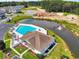 Community pool with clubhouse near pond at 1411 Gooseneck Place # 103, Murrells Inlet, SC 29576