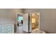 Spacious bedroom with an ensuite bathroom and access to another room at 1411 Gooseneck Place # 103, Murrells Inlet, SC 29576