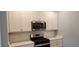 Modern kitchen with stainless steel appliances and white cabinets at 1411 Gooseneck Place # 103, Murrells Inlet, SC 29576