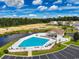 Community pool with clubhouse and surrounding landscape at 1411 Gooseneck Place # 103, Murrells Inlet, SC 29576