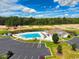 Community pool with clubhouse and surrounding landscape at 1411 Gooseneck Place # 103, Murrells Inlet, SC 29576