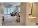Open living room with hardwood floors, access to a patio, and a half bath at 1411 Gooseneck Place # 103, Murrells Inlet, SC 29576