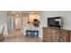 Open living room with kitchen island and a TV cabinet at 1411 Gooseneck Place # 103, Murrells Inlet, SC 29576