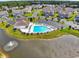 Community pool with clubhouse and pond at 1411 Gooseneck Place # 103, Murrells Inlet, SC 29576