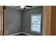 Small bedroom with gray walls, wood flooring and a window at 1411 Gooseneck Place # 103, Murrells Inlet, SC 29576