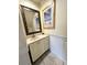 Clean bathroom with white vanity, mosaic mirror, and wainscoting at 306 21St Ave. S # 4A, Myrtle Beach, SC 29577