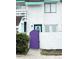 Exterior view of a townhome with purple gate and teal door at 306 21St Ave. S # 4A, Myrtle Beach, SC 29577