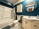 Teal-walled bathroom with white vanity, shower/tub combo, and patterned floor at 306 21St Ave. S # 4A, Myrtle Beach, SC 29577