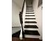 Indoor staircase with dark wood steps and white railings at 306 21St Ave. S # 4A, Myrtle Beach, SC 29577