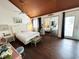 Main bedroom with high ceiling, dark hardwood floors, and private balcony access at 306 21St Ave. S # 4A, Myrtle Beach, SC 29577