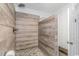 Large walk-in shower with rustic wood-look tile and pebble flooring at 3815 Ed Smith Ave., Myrtle Beach, SC 29588
