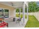Covered patio with seating area and fenced backyard at 3722 White Wing Circle, Myrtle Beach, SC 29579