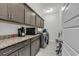 Convenient laundry room with granite countertops and cabinets at 3722 White Wing Circle, Myrtle Beach, SC 29579
