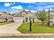 Two-story house with a tan and brown exterior, a two-car garage, and a well-maintained lawn at 3722 White Wing Circle, Myrtle Beach, SC 29579