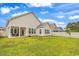 Large backyard with covered patio and neighboring houses at 3722 White Wing Circle, Myrtle Beach, SC 29579