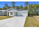 Newly constructed home with gray siding, white trim, and a two-car garage at 385 Sun Colony Blvd., Longs, SC 29568