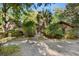 Brick house with a walkway, lush landscaping, and a gated entry at 19 South Gate Rd., Myrtle Beach, SC 29572