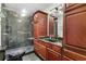 Bathroom boasts granite countertops, dark wood cabinets, and a large shower at 19 South Gate Rd., Myrtle Beach, SC 29572