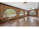 Sunroom features brick walls, arched windows, and tile flooring at 19 South Gate Rd., Myrtle Beach, SC 29572