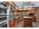 Kitchen with granite countertops, wood cabinets, and stainless steel appliances at 19 South Gate Rd., Myrtle Beach, SC 29572