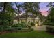 Evening view of charming house with mature trees and well-manicured lawn at 5714 Springs Ave., Myrtle Beach, SC 29577