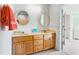 Double vanity bathroom with light wood cabinets and a large mirror at 108 Burlington St. W, Holden Beach, NC 28462
