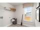 Bright laundry room features shelving, window, and vinyl flooring at 1889 Brook Park Pl., Conway, SC 29526