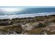 Aerial view of beachfront property with ocean and sand dunes at 3539 Rayner Cove Ct., Little River, SC 29566