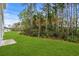 Spacious backyard with grassy area and wooded backdrop at 3539 Rayner Cove Ct., Little River, SC 29566