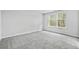 Bright bedroom with gray carpet and two windows at 3539 Rayner Cove Ct., Little River, SC 29566