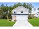 Two-story house with gray siding, peach door, and two-car garage at 3539 Rayner Cove Ct., Little River, SC 29566