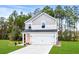 Two-story home with two-car garage and landscaped lawn at 3539 Rayner Cove Ct., Little River, SC 29566