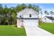 Two-story home with two-car garage and landscaped lawn at 3539 Rayner Cove Ct., Little River, SC 29566