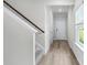 Hallway with stairs leading upstairs and light hardwood floors at 3539 Rayner Cove Ct., Little River, SC 29566