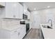 Modern kitchen with white cabinets, quartz countertops, and stainless steel appliances at 3539 Rayner Cove Ct., Little River, SC 29566