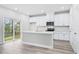 Modern kitchen with white cabinets, island, and stainless steel appliances at 3539 Rayner Cove Ct., Little River, SC 29566